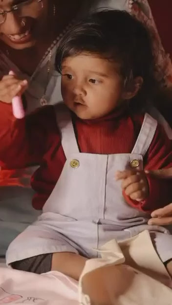 Load video: Child coloring our unique frock with washable colors